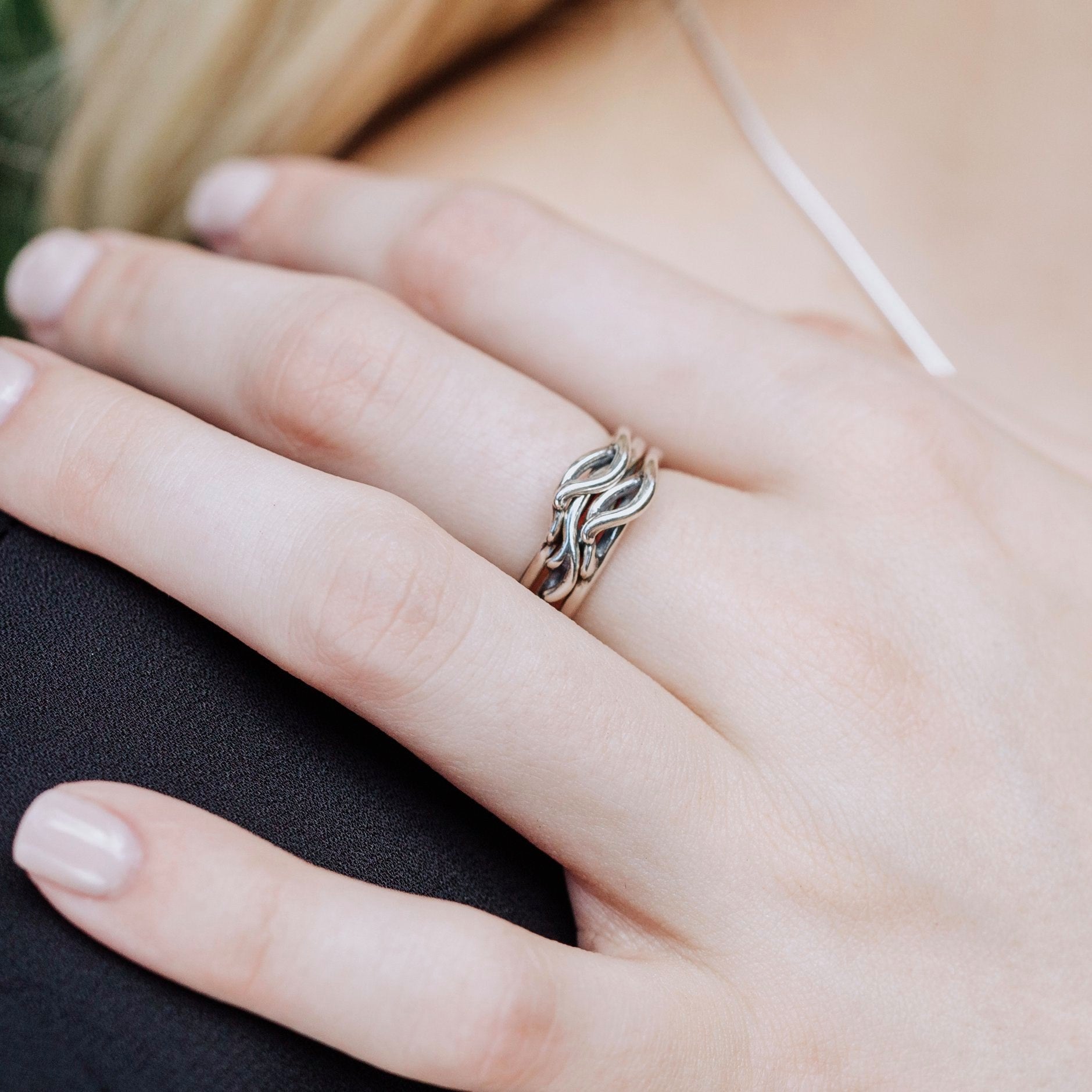 Close-up of a woman's hand wearing a silver Spanish Moss ring.