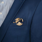 Navy blue blazer with a gold dragon pocket square on the chest pocket, worn over a patterned shirt.