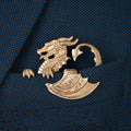 Gilded dragon pocket square on a textured blue fabric jacket pocket
