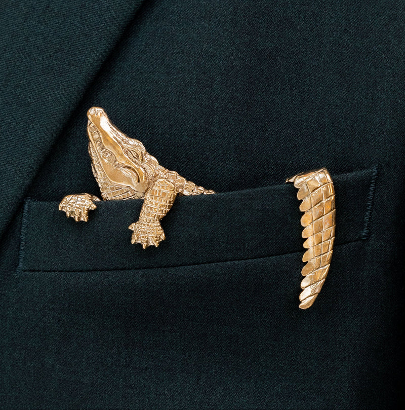Gilded bronze alligator pocket square worn in a dark suit jacket pocket