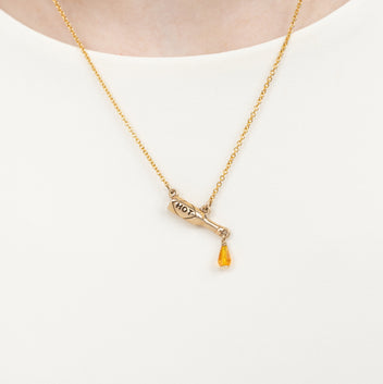 a person wearing a gold necklace