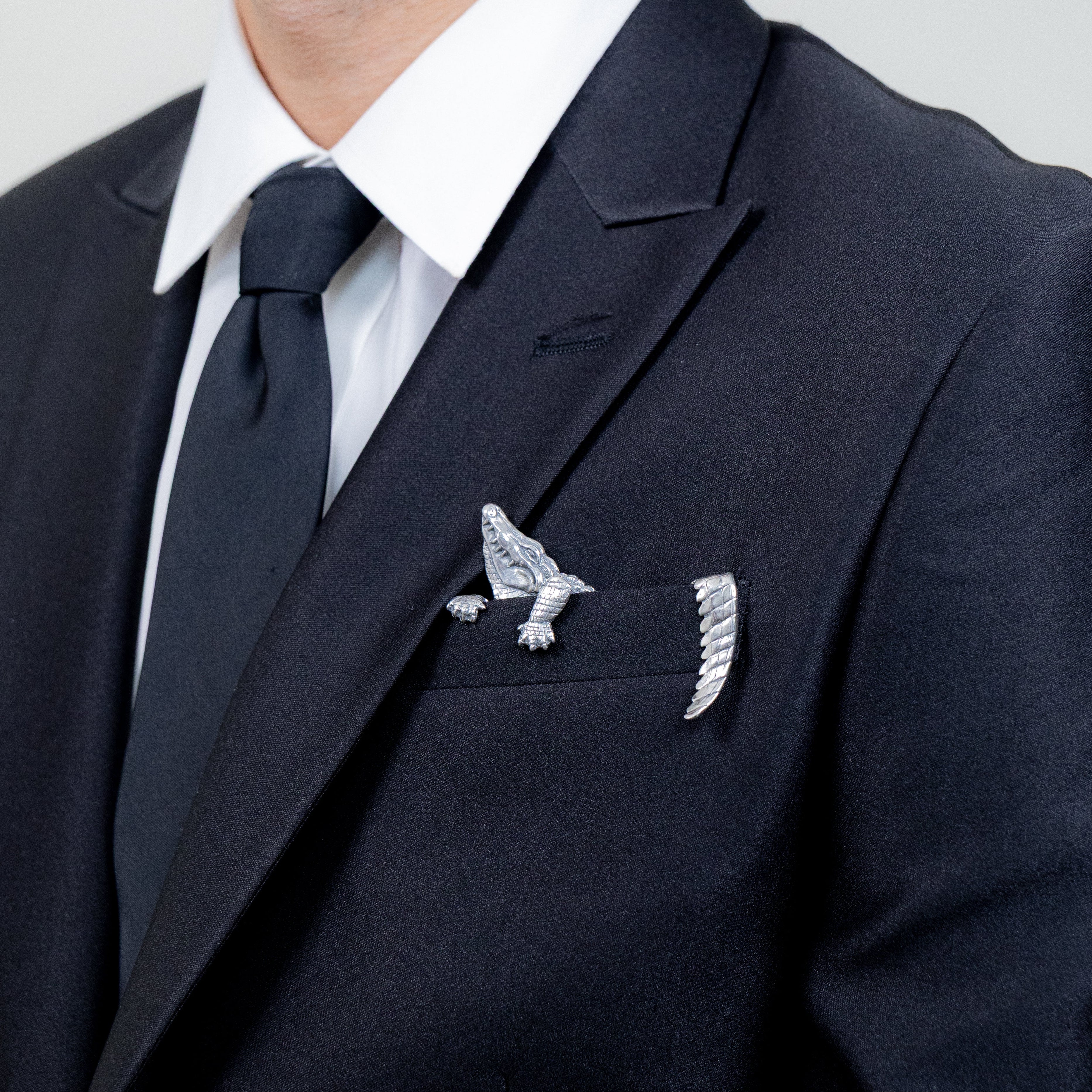 Sterling silver alligator pocket square worn with tailored formal jacket