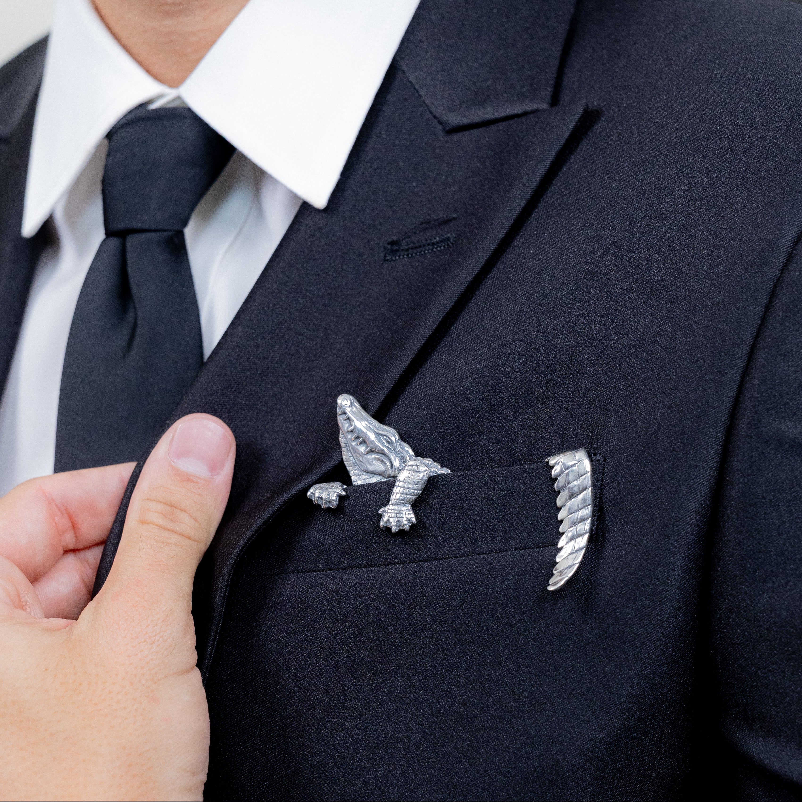Sterling silver alligator pocket square styled with black business suit