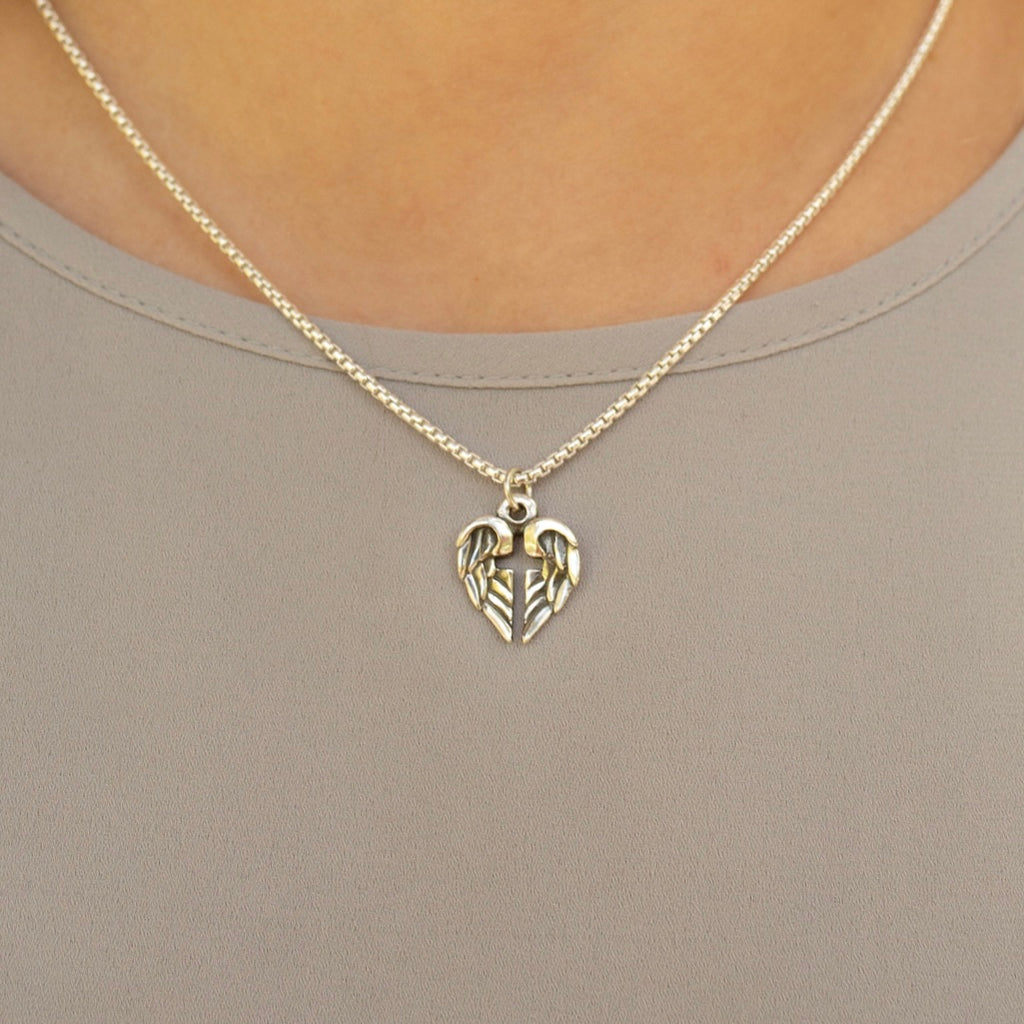 woman wearing angel wing cross pendant sterling silver