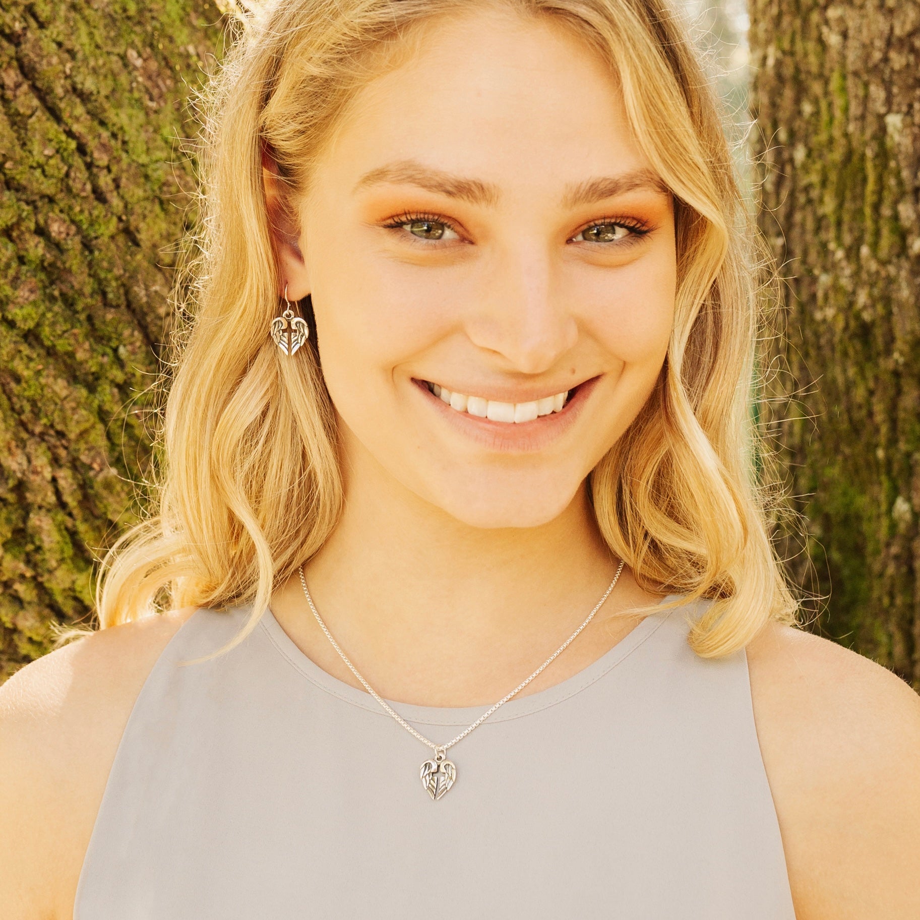 woman wearing angel of hope earrings in sterling silver