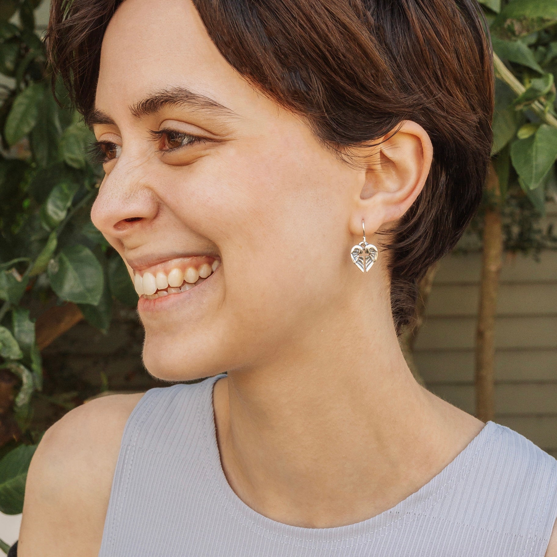 woman wearing small angel of hope earrings