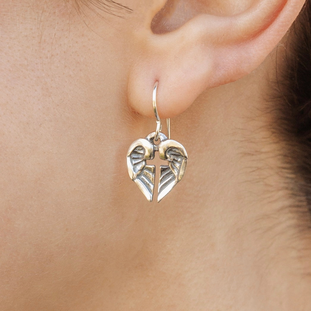 small sterling silver angel of hope earrings worn with angel wing cross design