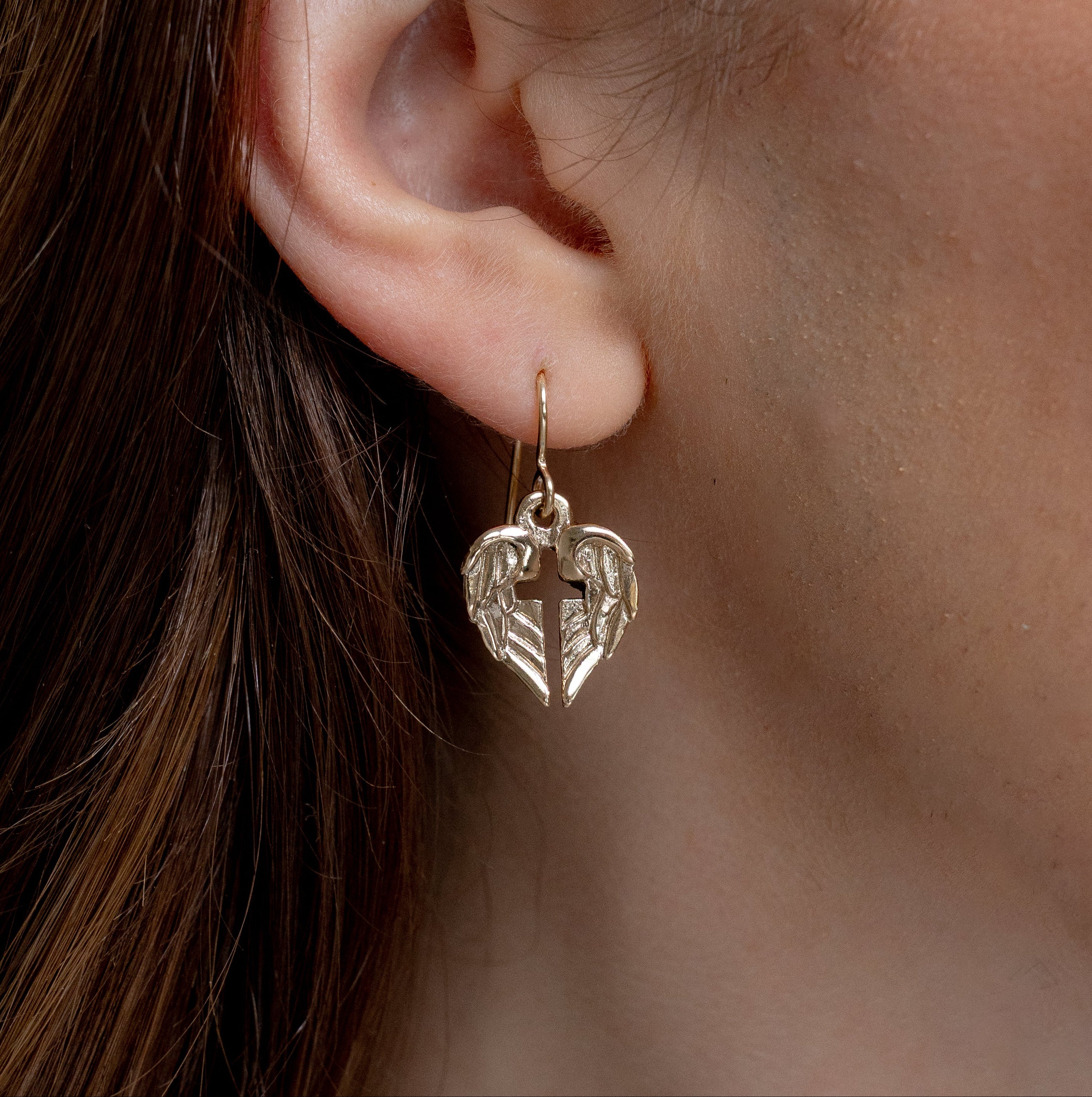 bronze angel of hope earrings worn with angel wings forming a cross