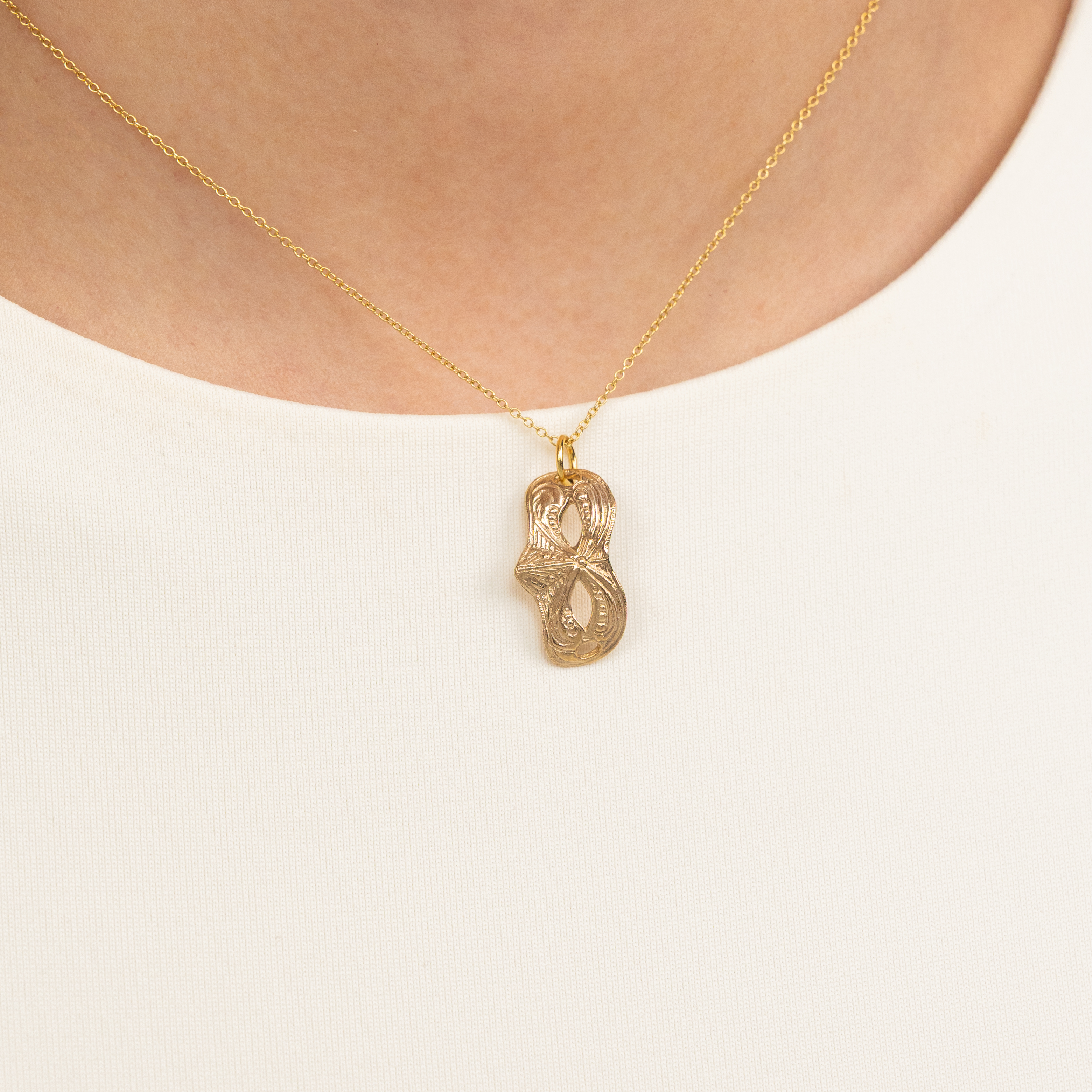 Bronze Mardi Gras Mask Pendant worn on a model, showcasing scale and warm bronze tone