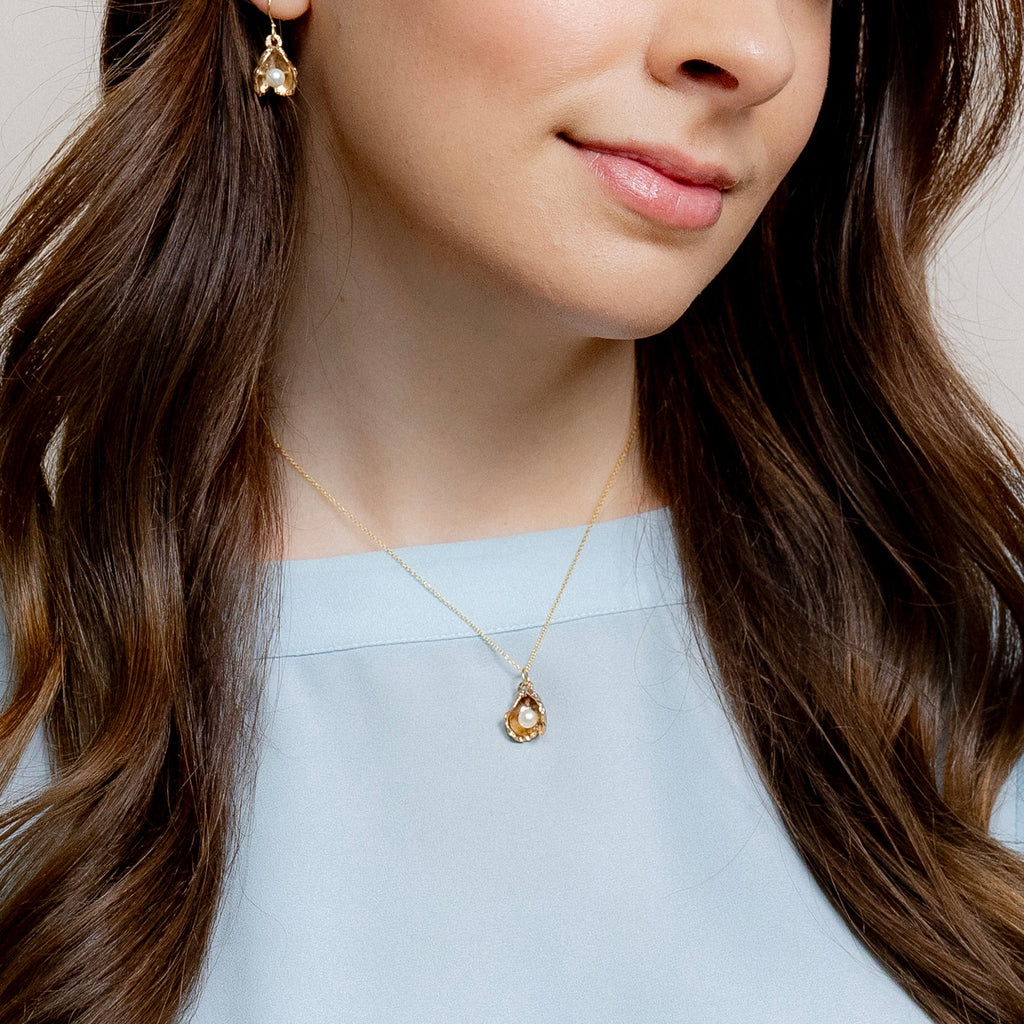 woman wearing bronze oyster pearl pendant new orleans jewelry gift idea