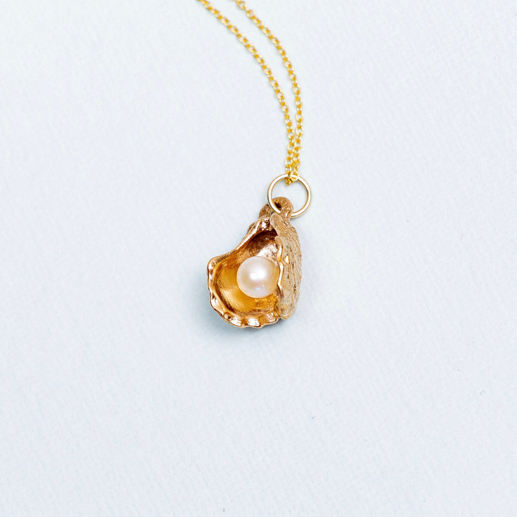 bronze oyster pearl pendant with freshwater pearl inside hand carved oyster shell