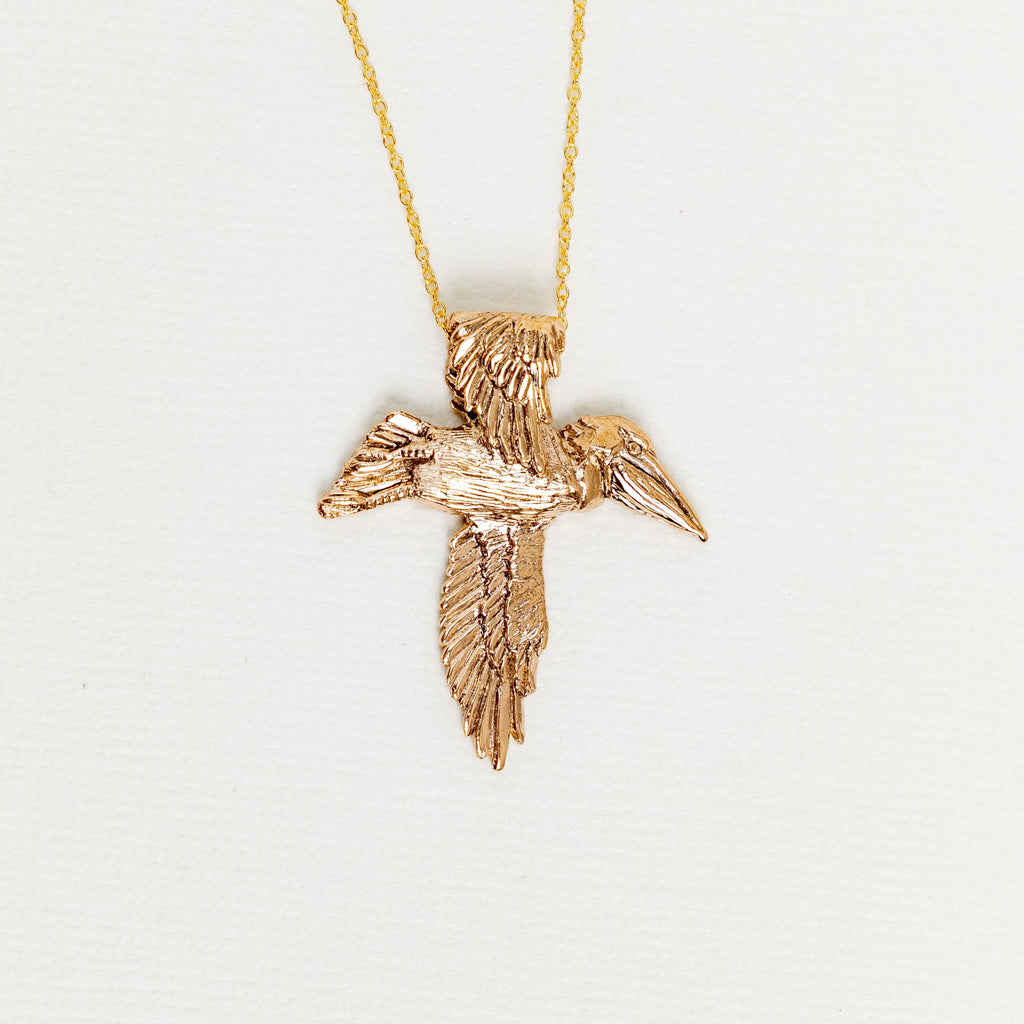 Bronze pelican cross pendant necklace designed by Jose Balli