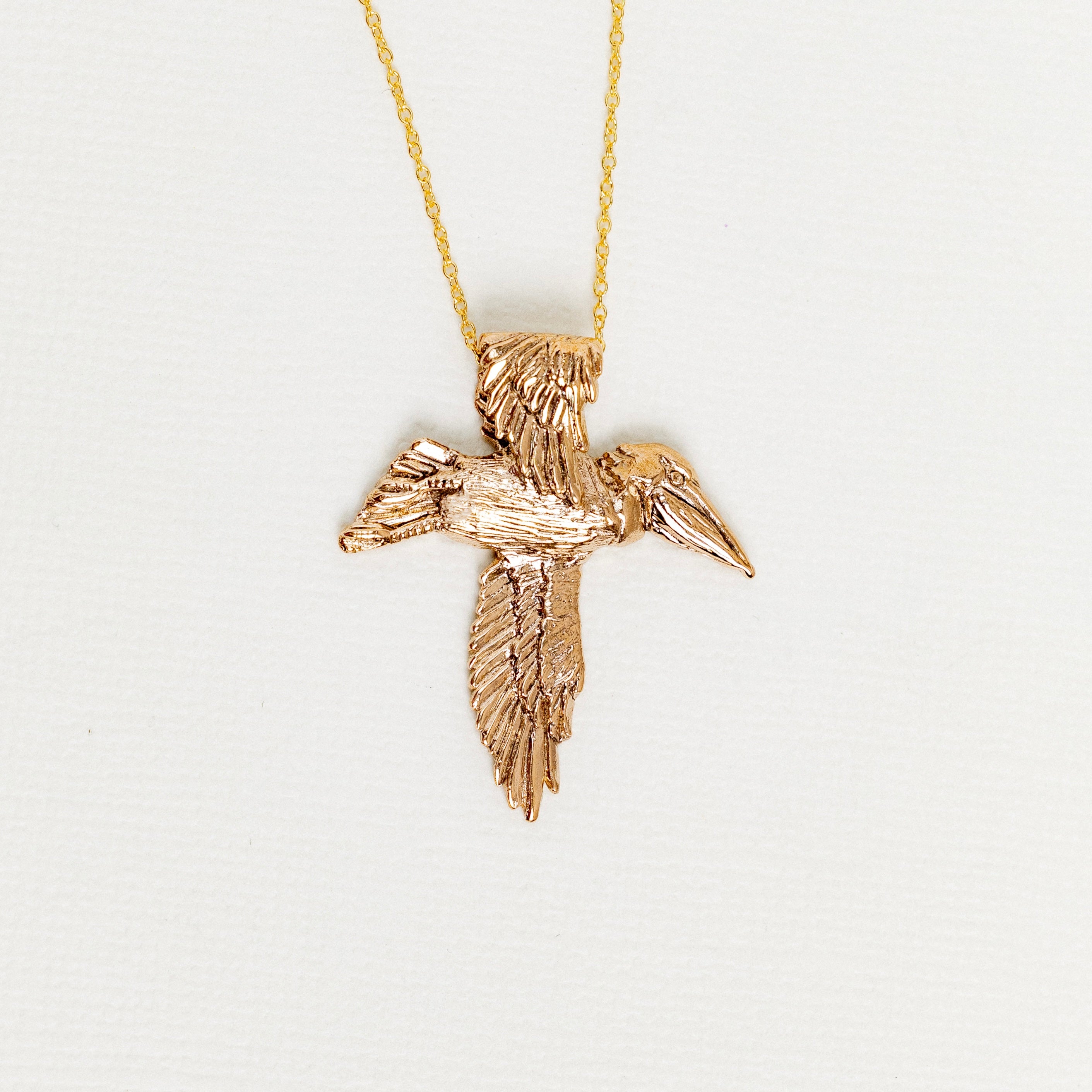 Bronze pelican cross pendant necklace designed by Jose Balli