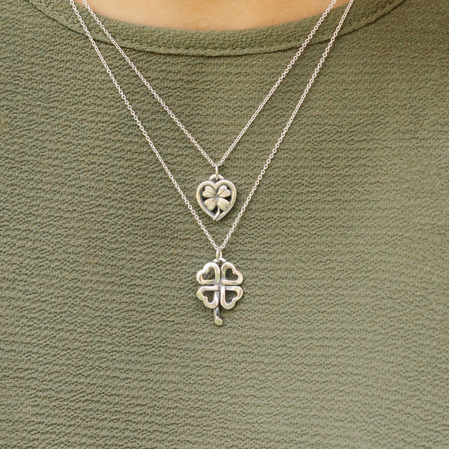 sterling silver celtic clover pendant layered with necklace on model green top everyday jewelry styling