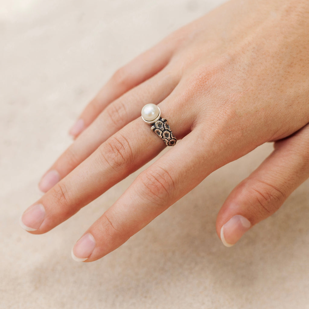 coquille oyster pearl ring worn on hand showing delicate feminine scale and detail