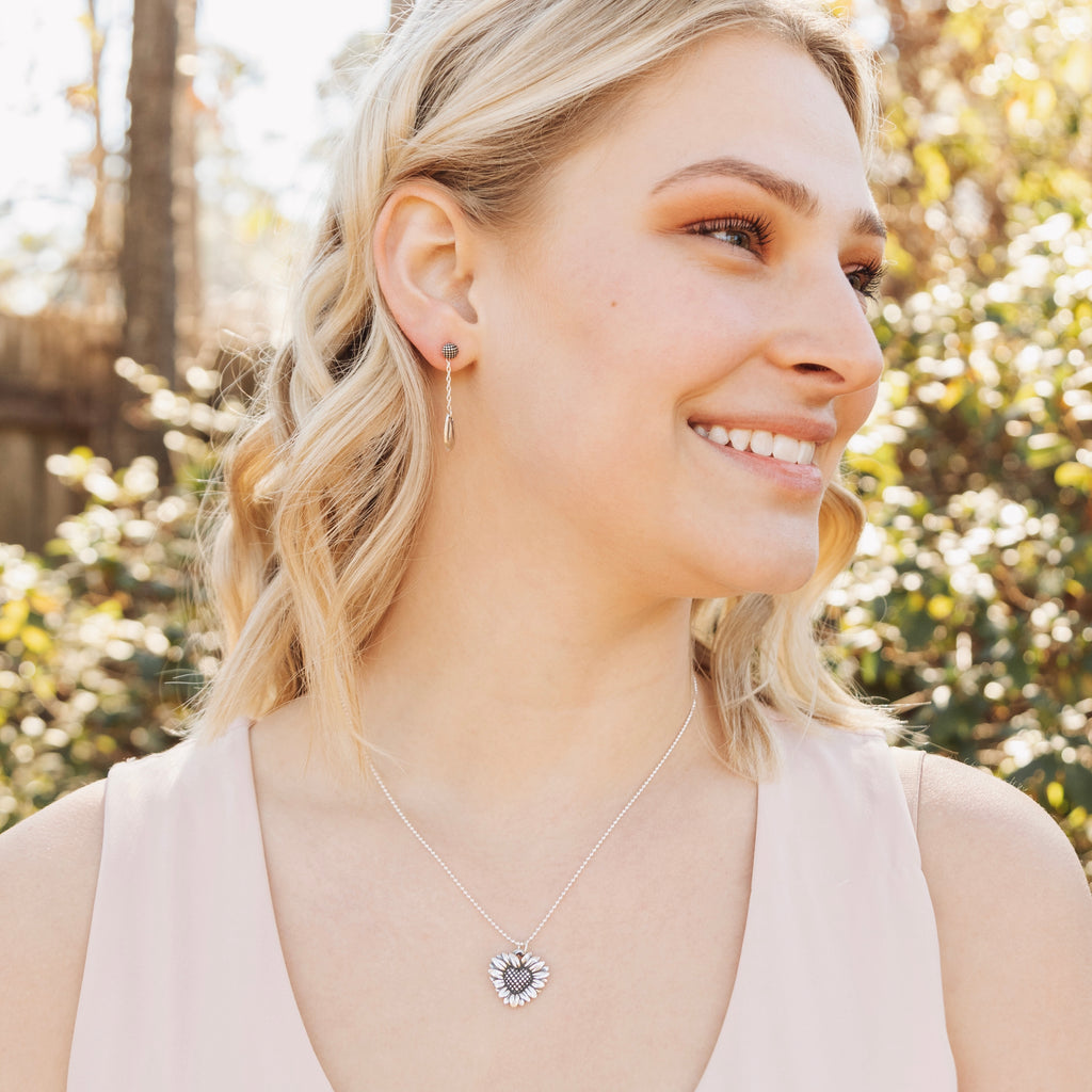 daisy heart pendant worn on model