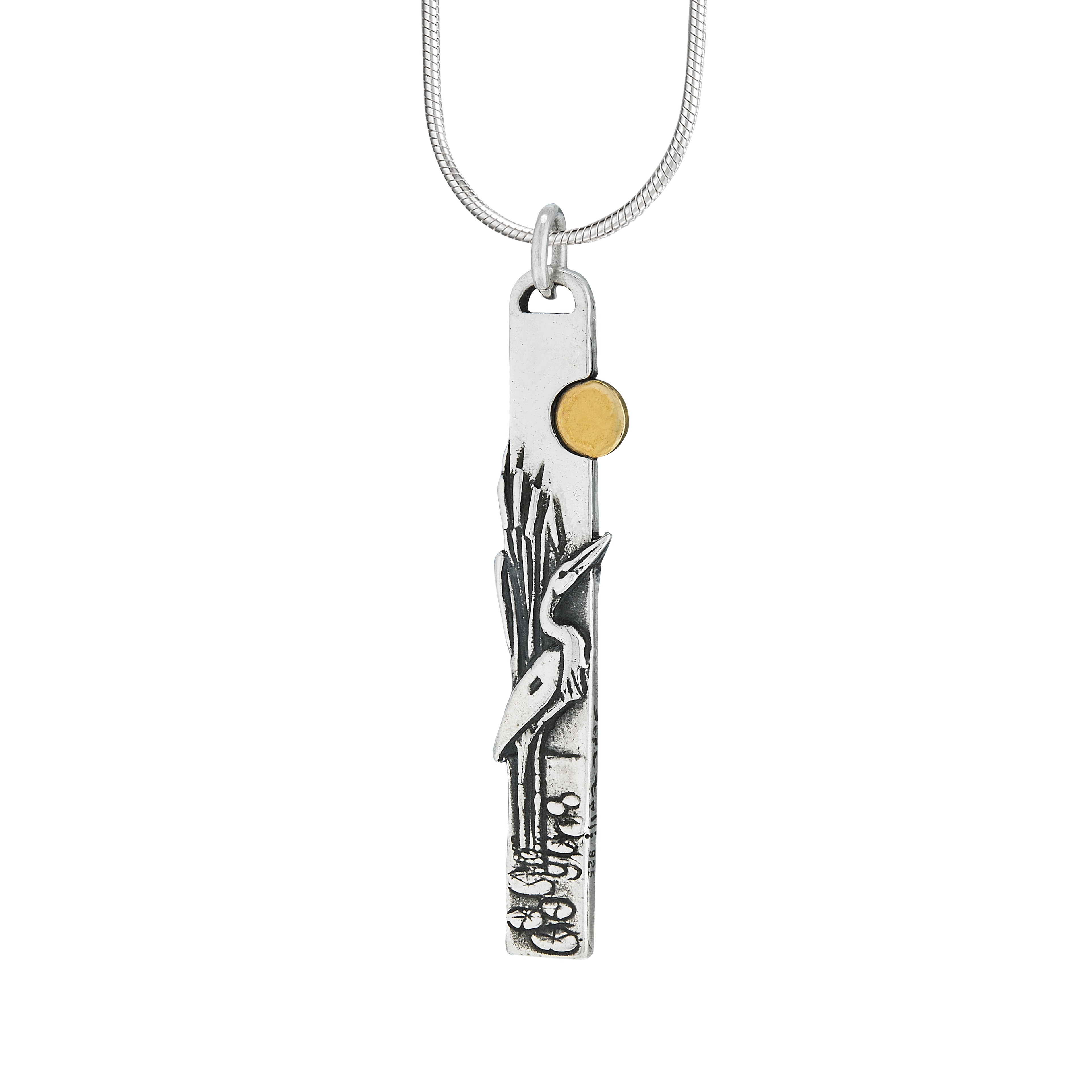 Egret bird pendant standing among cattails with brass sun