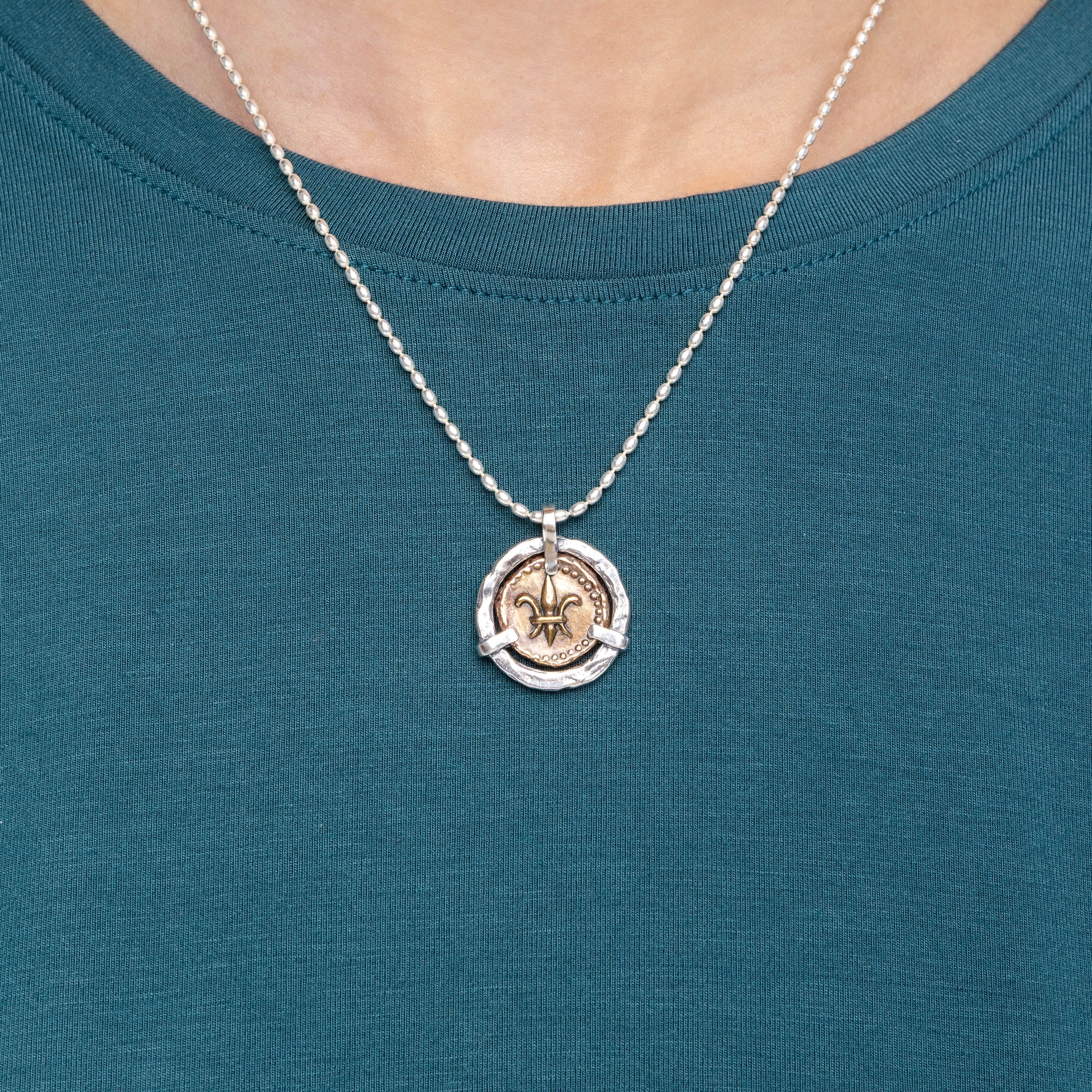 Fleur de lis doubloon pendant necklace worn on model