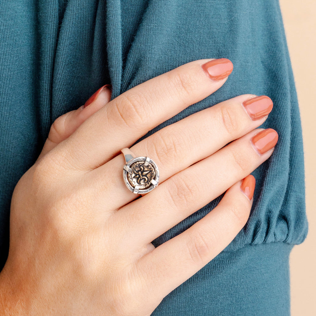 Fleur de lis doubloon ring worn on hand
