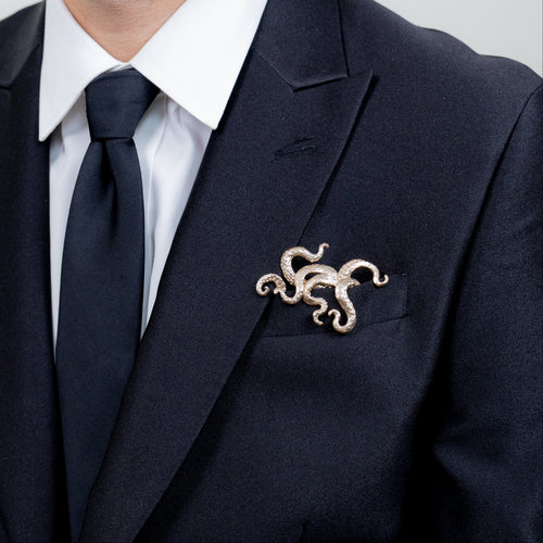 Gilded bronze kraken pocket square worn in formal black suit jacket with tie