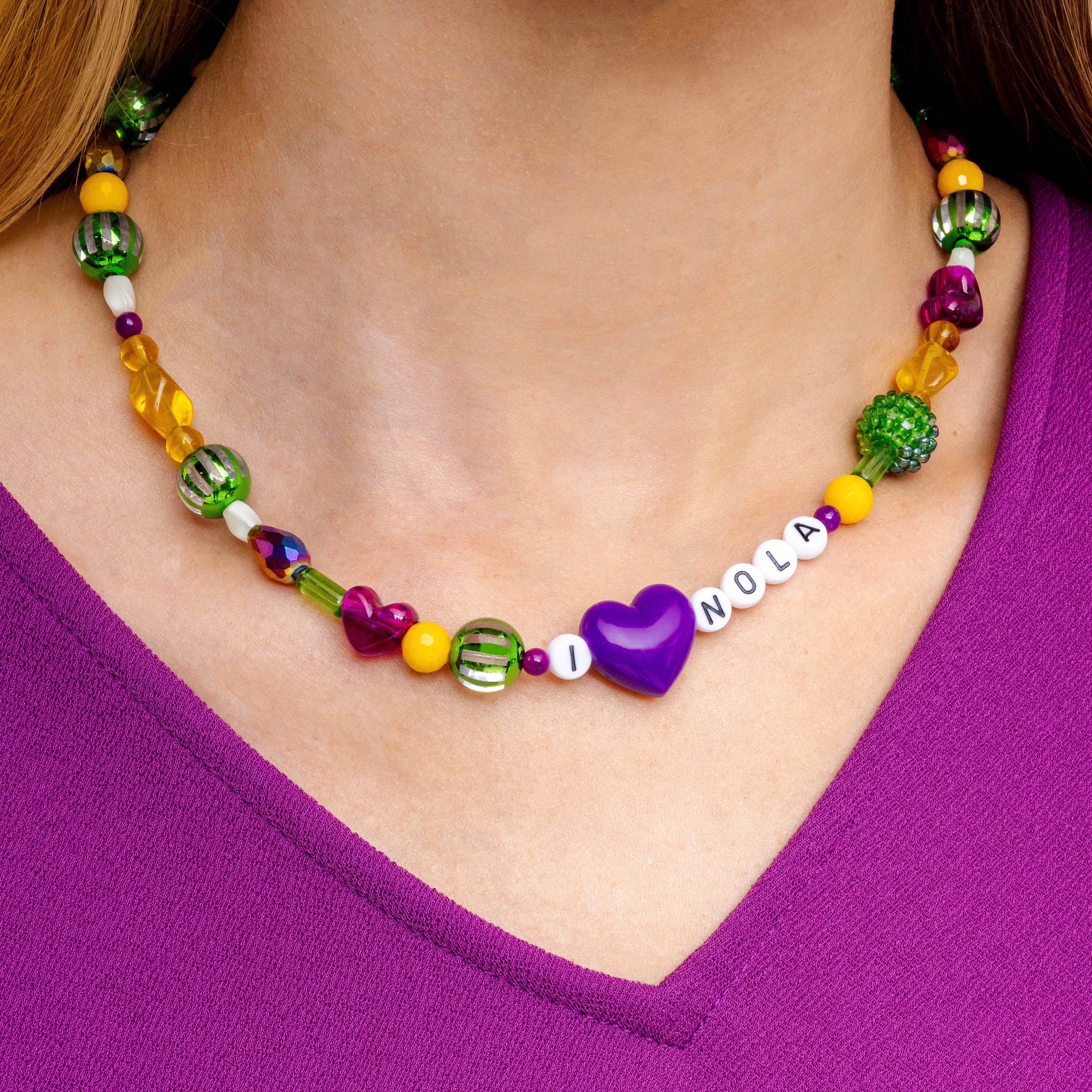 Woman wearing Mardi Gras Throw Necklace inspired by New Orleans Mardi Gras tradition