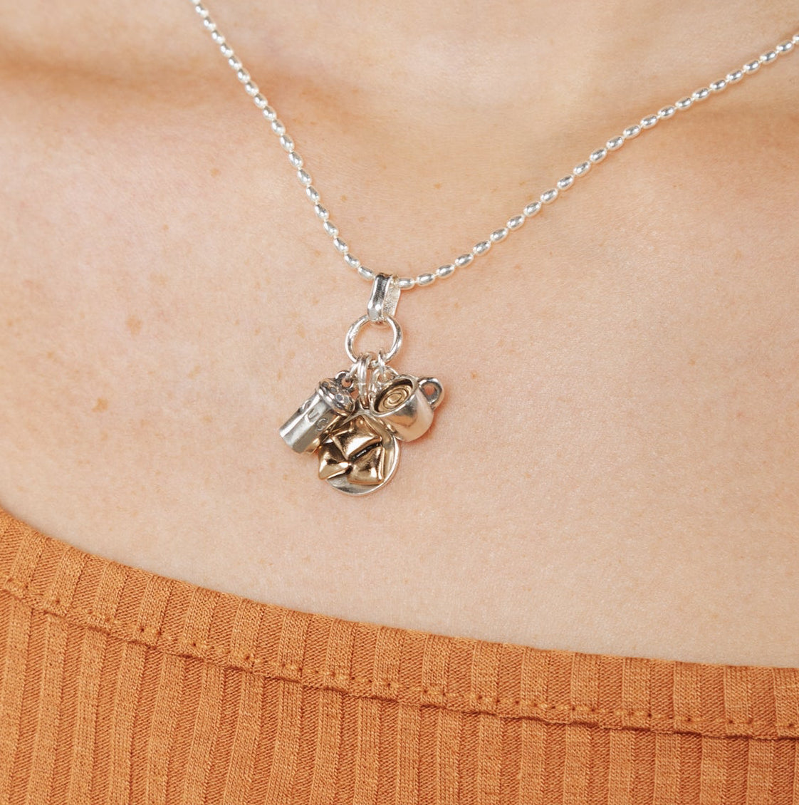 Sterling silver and bronze beignet pendant inspired by Cafe du Monde New Orleans