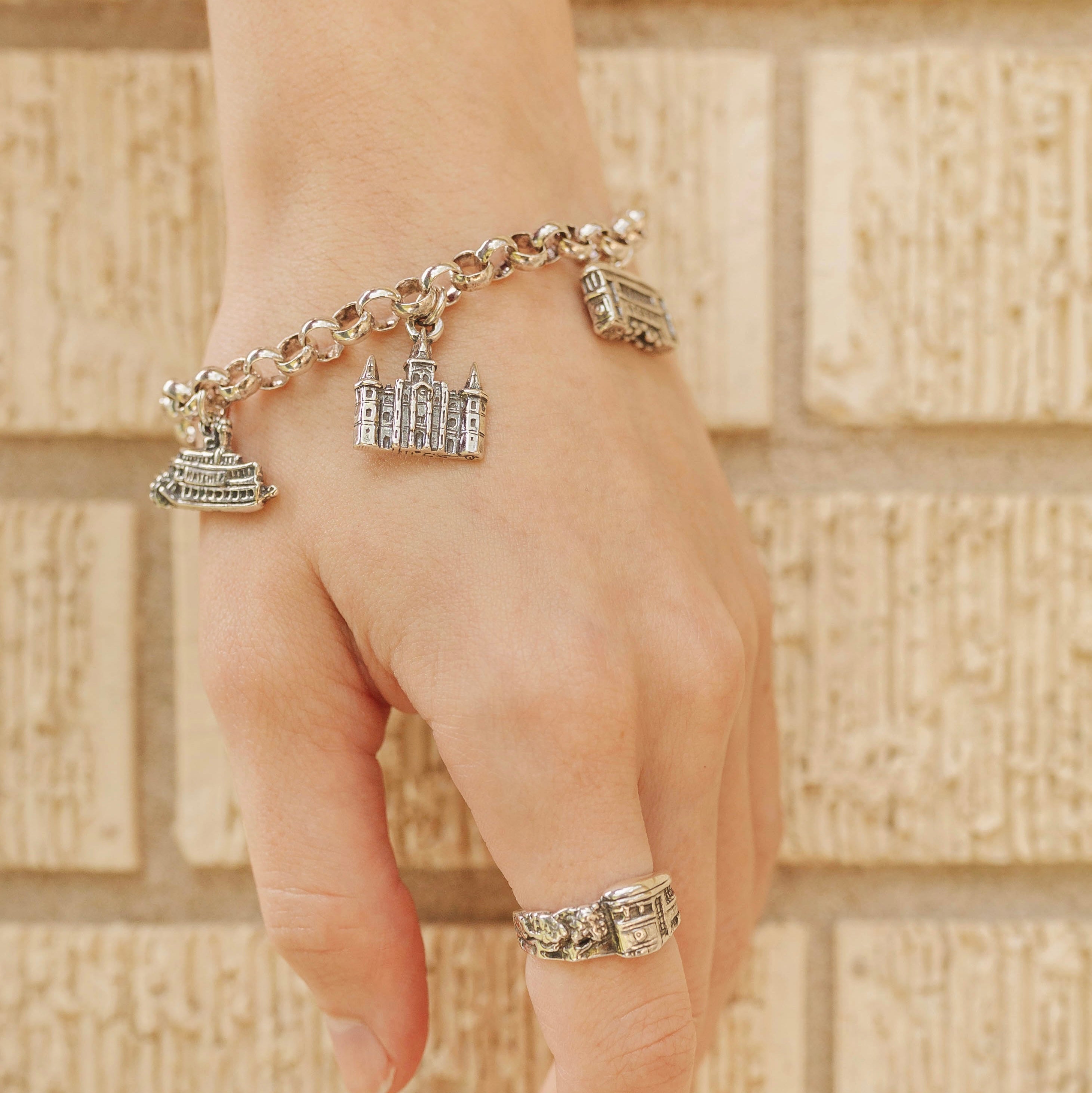 New Orleans French Quarter charm bracelet worn on wrist with landmark charms