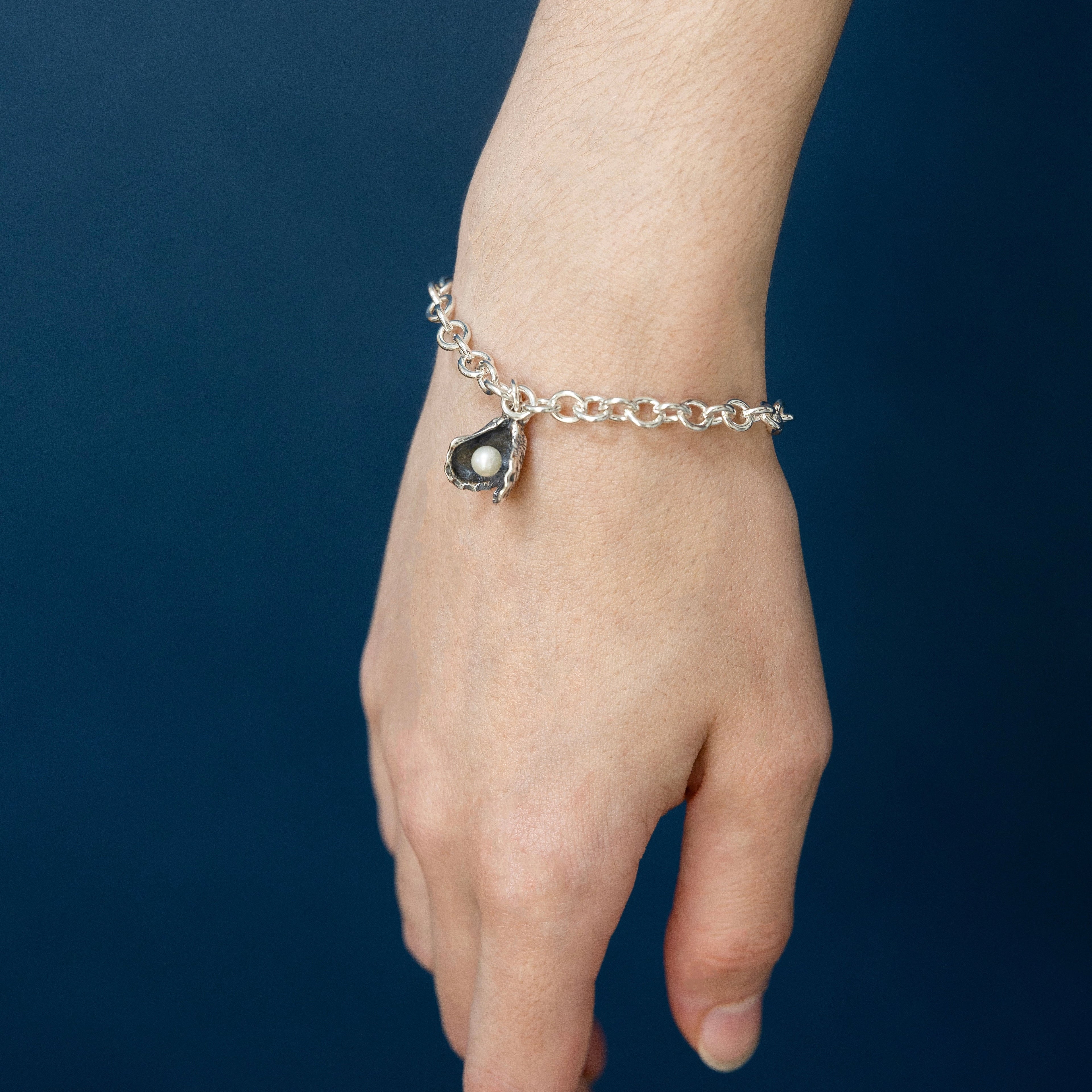 woman wearing oyster pearl bracelet everyday jewelry subtle coastal design