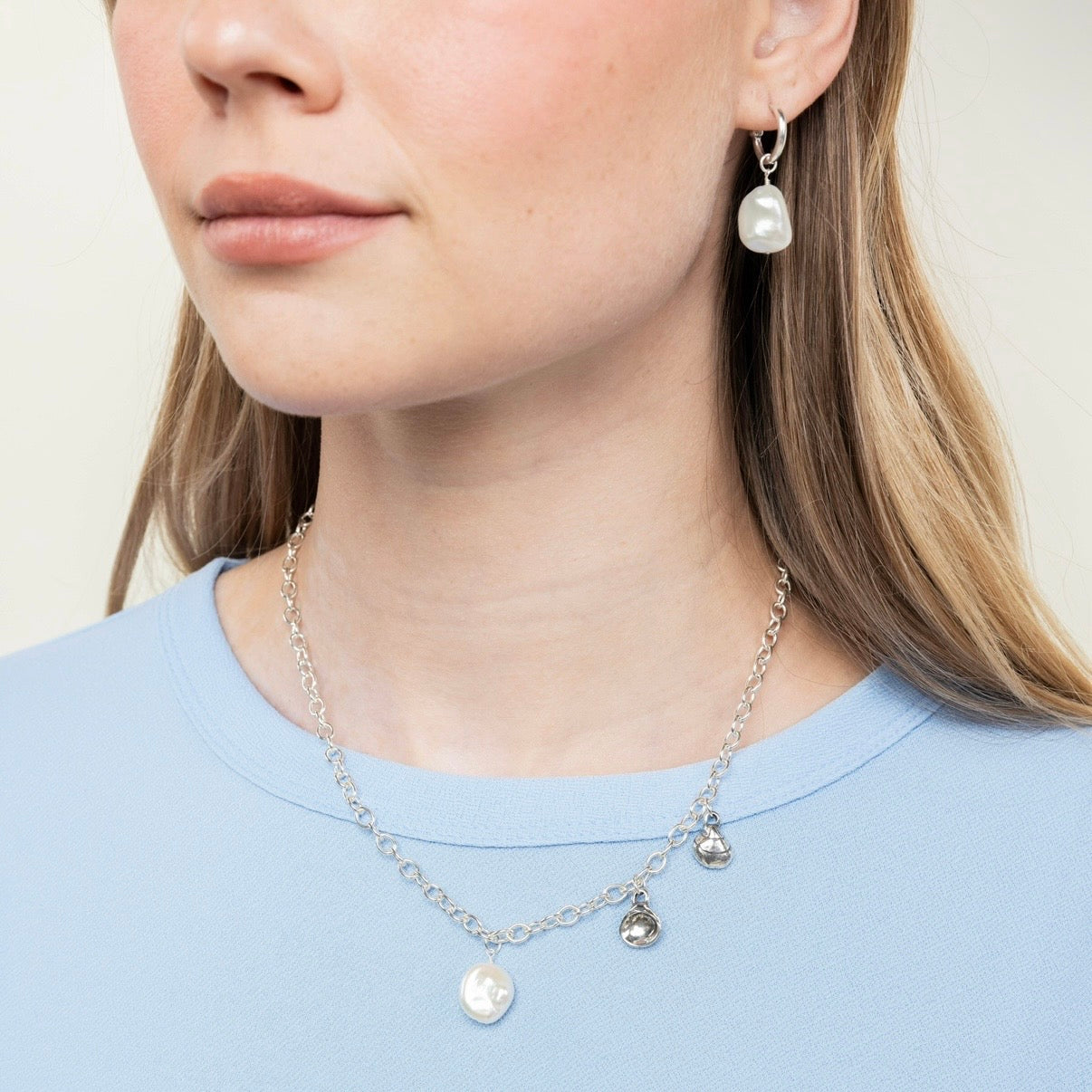 pearl hoop earrings worn front view with necklace