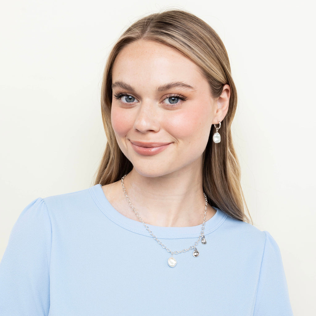 pearl hoop earrings styled on model with matching jewelry