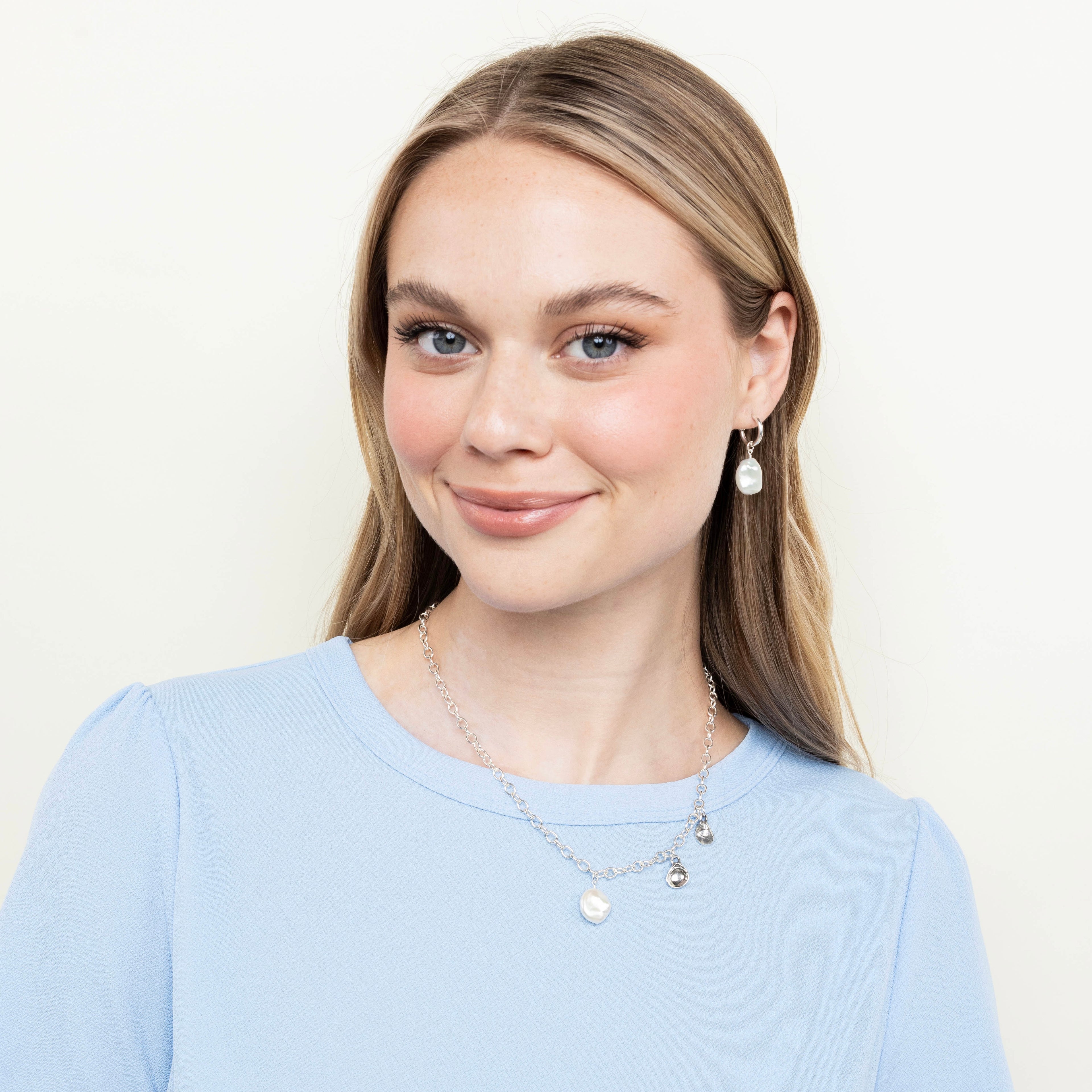 pearl hoop earrings styled on model with matching jewelry