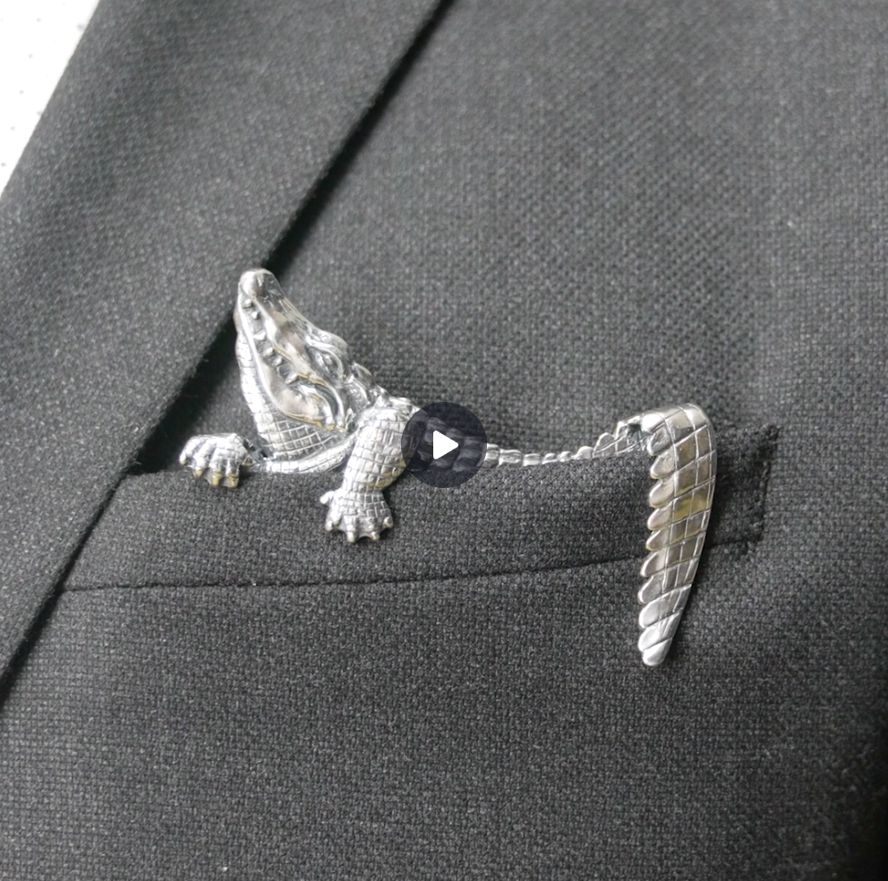 Sterling silver alligator pocket square sitting upright in jacket pocket