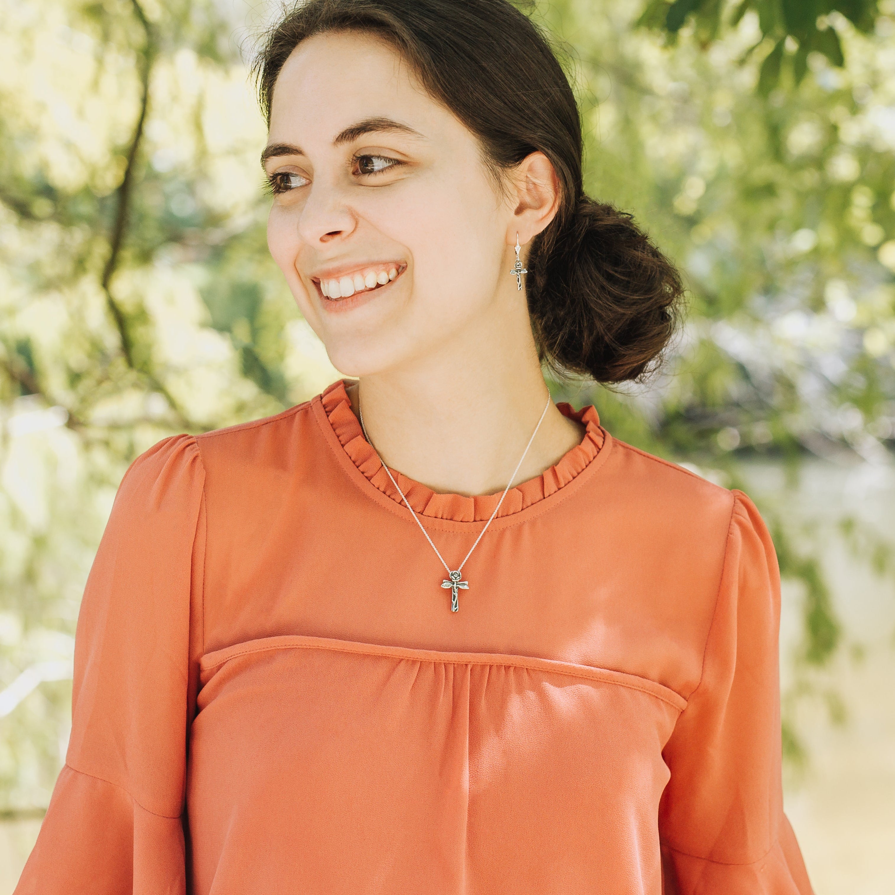 rose cross pendant worn on model 
