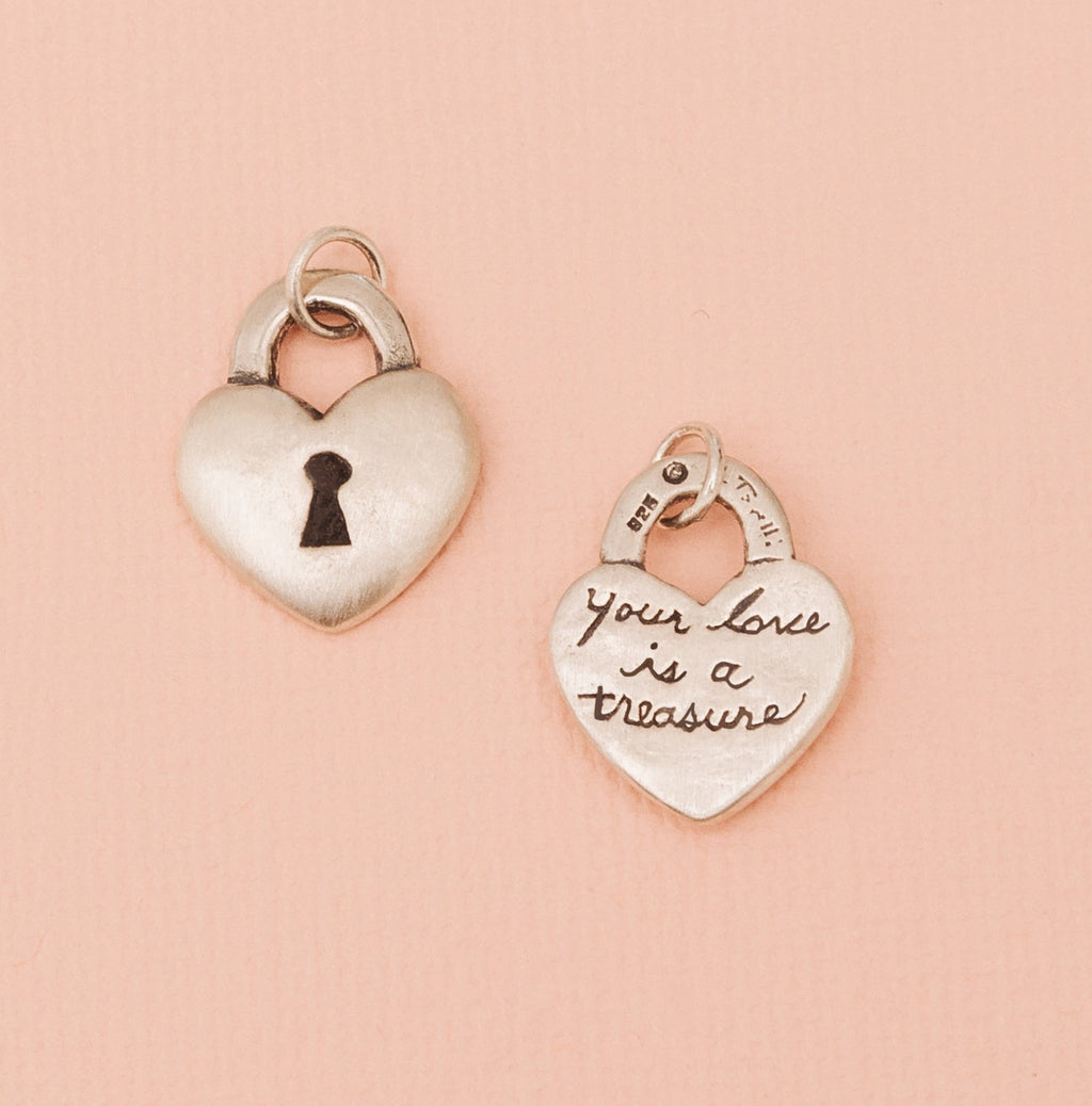 Front and back view of sterling silver heart lock pendant showing keyhole and engraved message