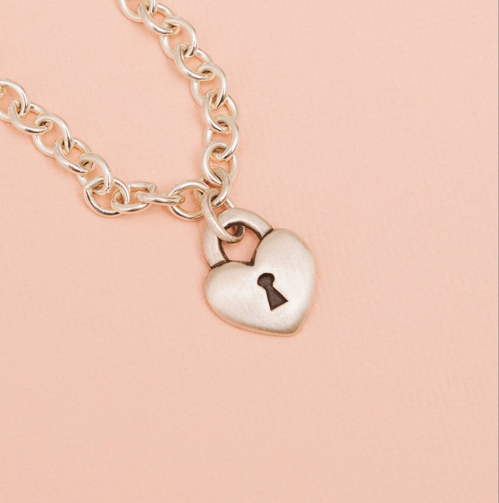 Sterling silver love lock heart chain necklace with keyhole detail front close up 