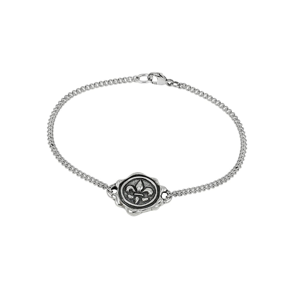 Silver bracelet with a wax stamp-shaped clasp on a white background