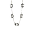 A sterling silver necklace featuring a series of double-sided blue crab charms on a chain.