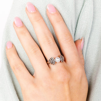 a hand with pink nails and a ring