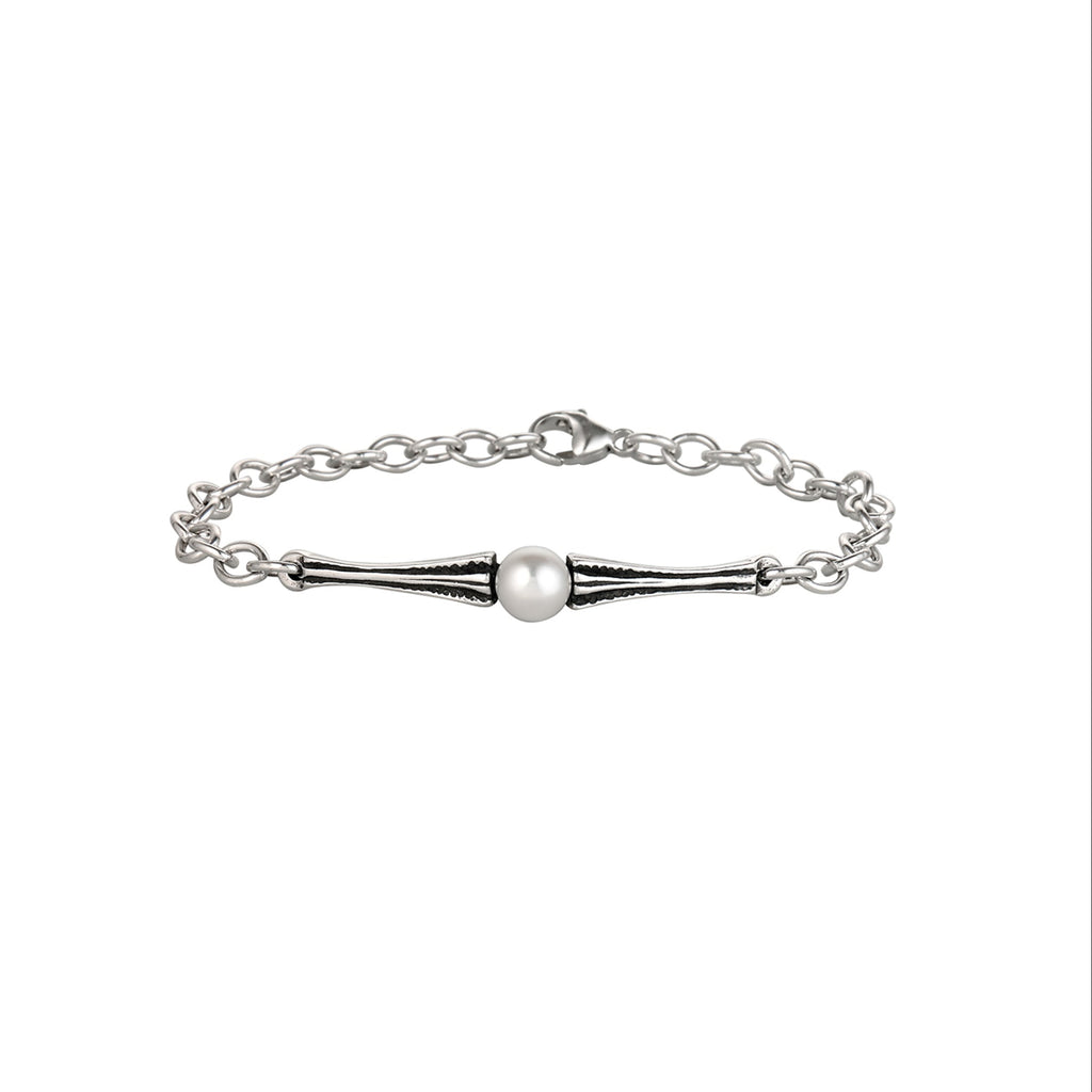 Silver bracelet with a single pearl on a white background