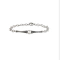 Silver bracelet with a single pearl on a white background