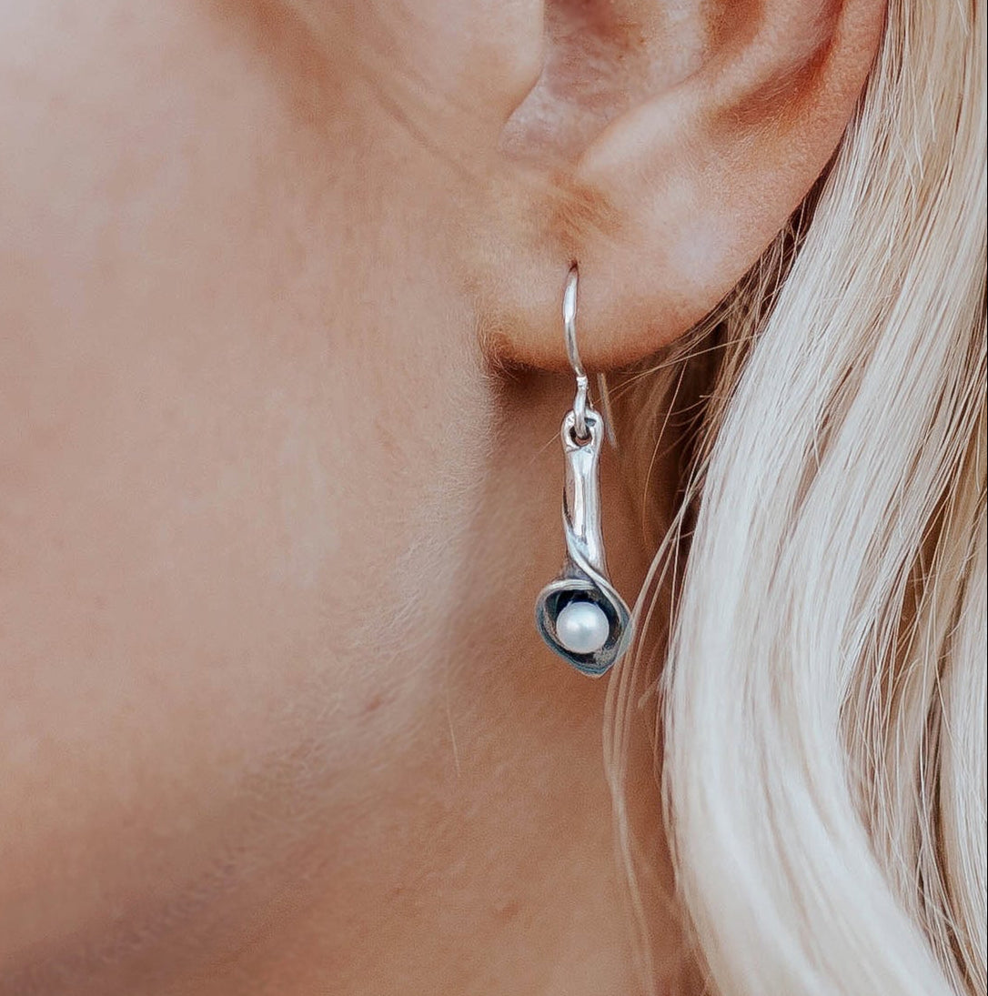Sterling silver calla lily pearl earrings worn on model