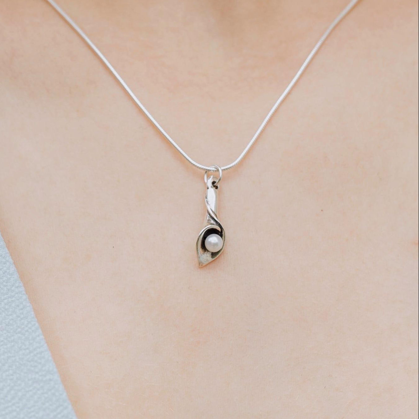 Sterling silver calla lily pearl necklace worn on model