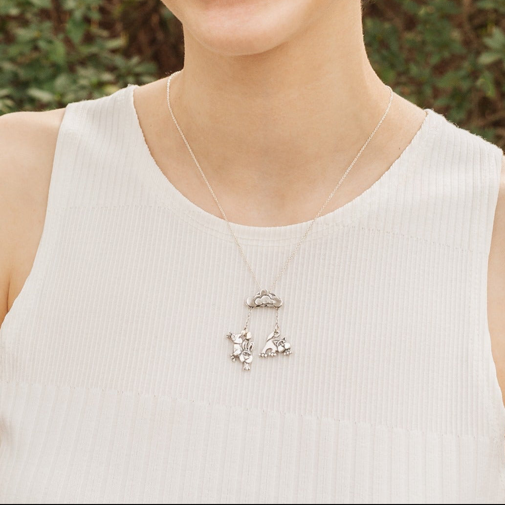 Sterling silver cat and dog pendant necklace worn on model