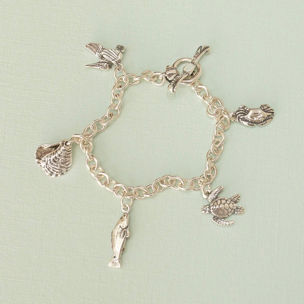 coastal charm bracelet laid flat showing multiple sea life charms and toggle clasp, handcrafted louisiana jewelry
