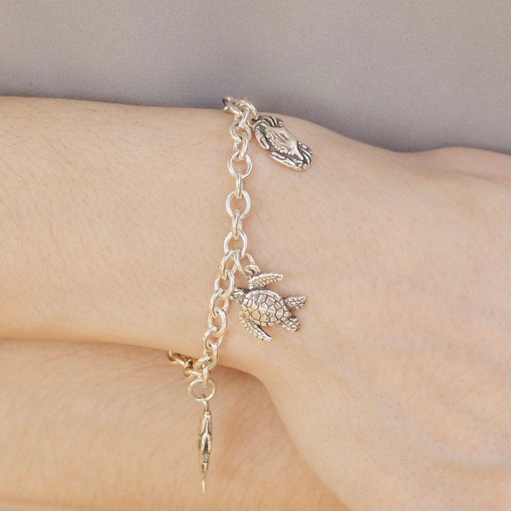 coastal charm bracelet worn on wrist showing detailed sea life charms inspired by louisiana coast