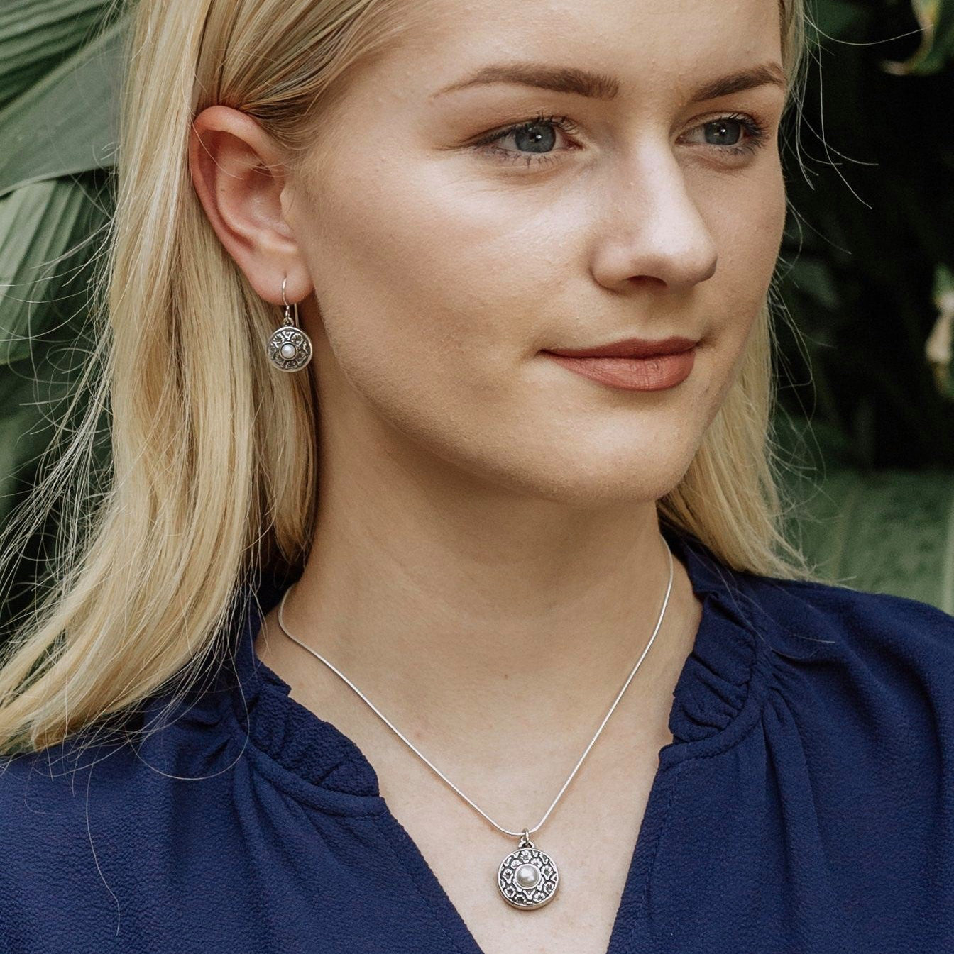 coquille pearl earrings worn with matching pendant showing coordinated jewelry set