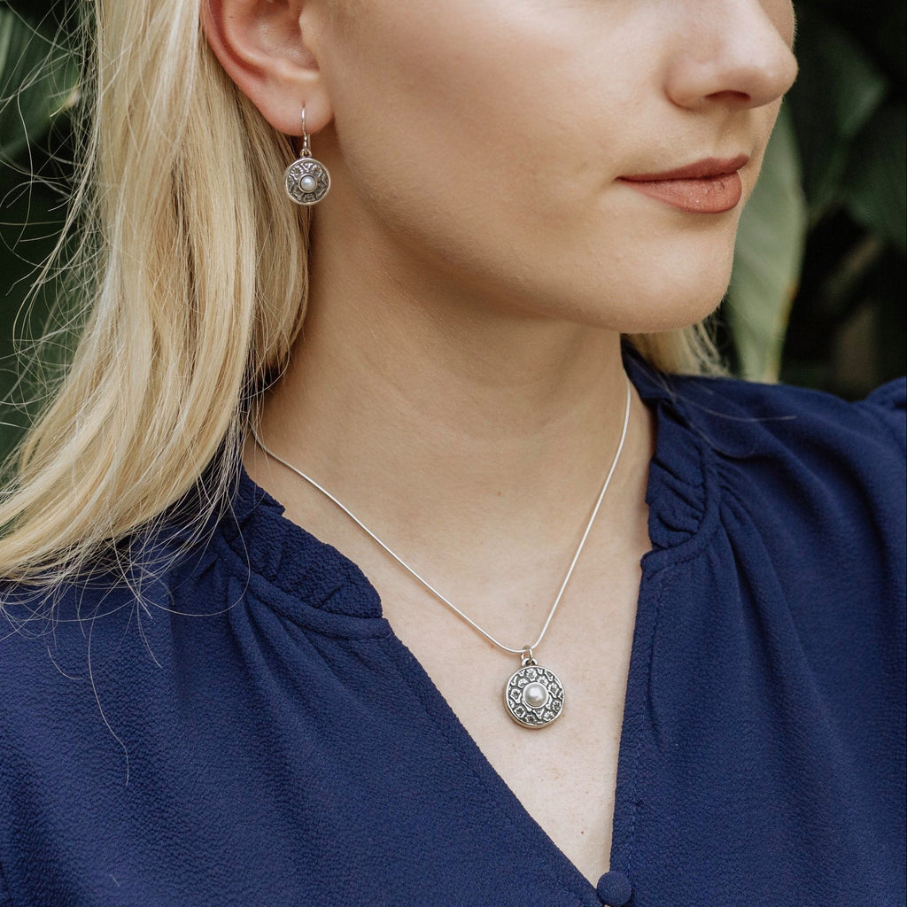 sterling silver coquille oyster pearl pendant worn with blouse showing feminine styling