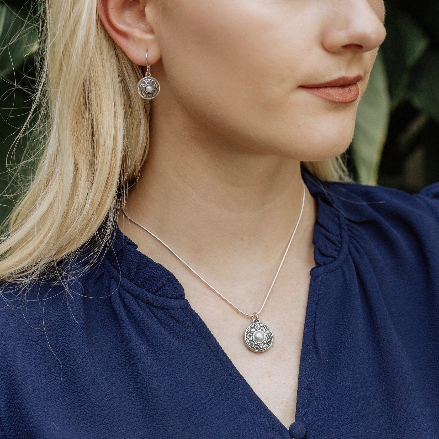 sterling silver coquille oyster pearl pendant worn with blouse showing feminine styling