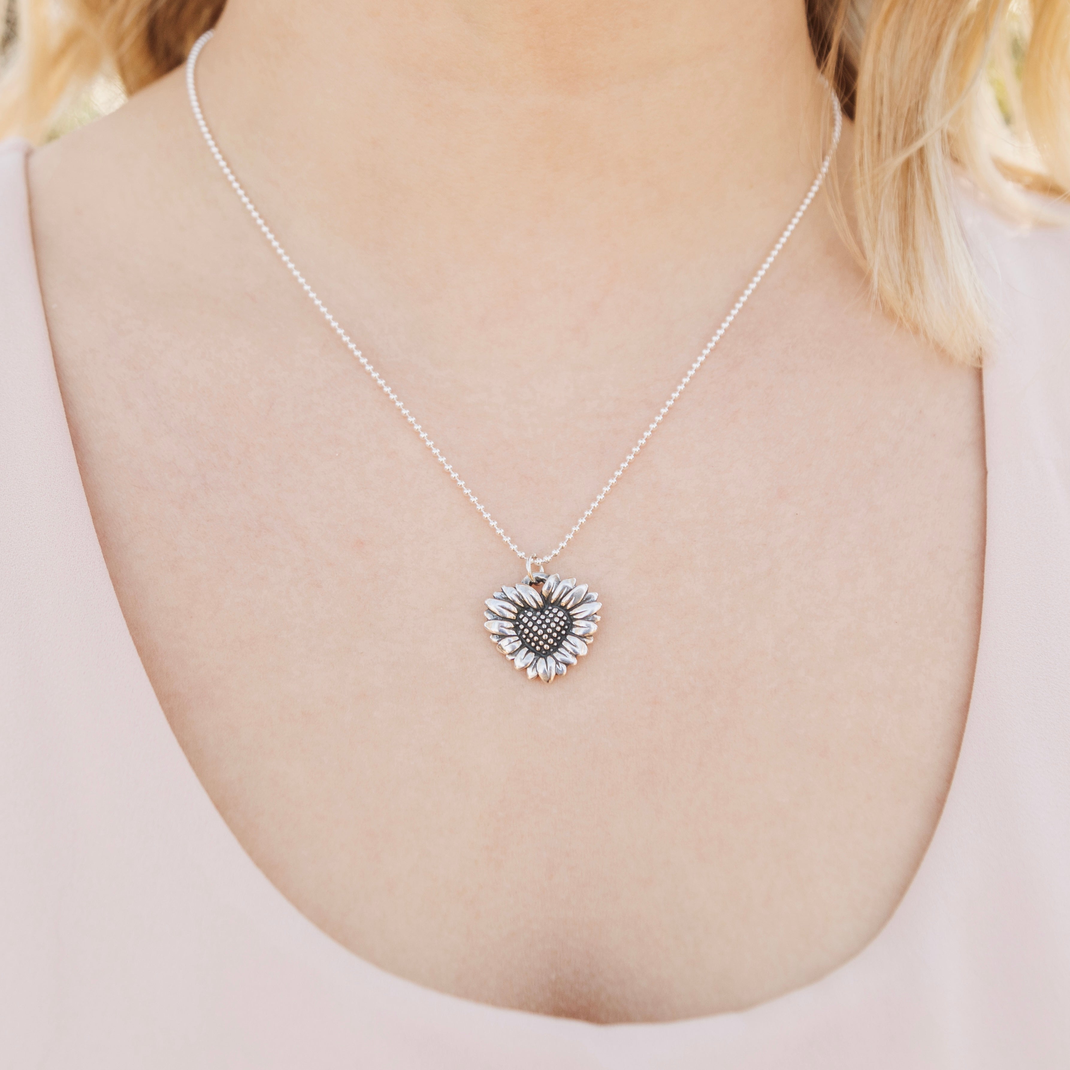 daisy heart pendant worn close on necklace