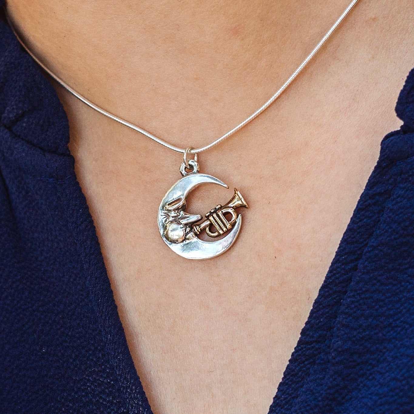 Handmade sterling silver jazz moon necklace worn on model, inspired by New Orleans music